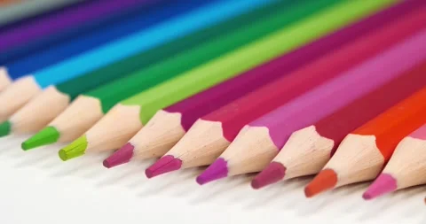 New beautiful multi-colored pencils lie on the white table Video stock 311833076