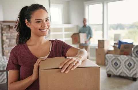 New beginnings...a young couple moving into their new home. Stock Photos