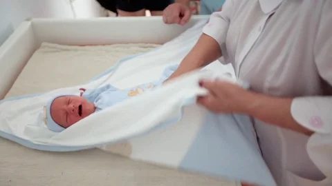 New born baby boy swaddled immediately a, Stock Video