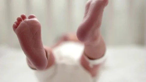 New Born baby's feet in cot Stock Video Pond5