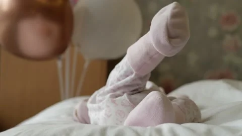 New born tiny feet on pastel blanket. Unrecognisable kid in the bed. Close up Video stock 165841790