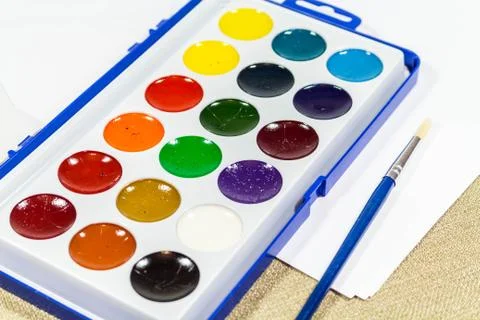 A new box with multi-colored paints and a brush for painting. Diagonally 写真素材