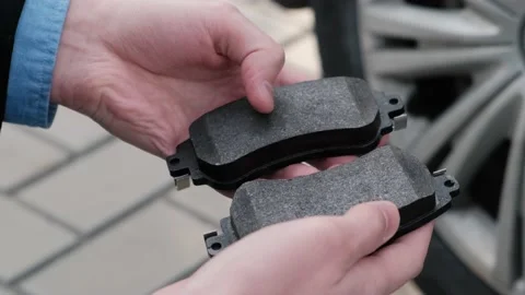 New brake pads in the hands of the driver or service worker Stock Footage 152233409