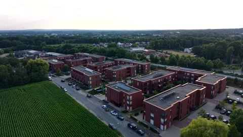 New brick apartment complex spreads beside cornfield in American suburb Stock Footage 340422796