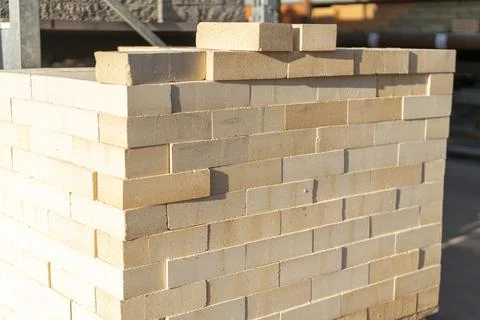 New brick block construction material on pallet. Beige bricks in the package Stock Photos