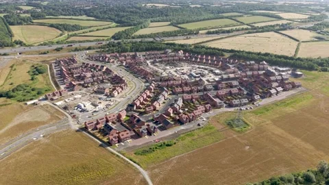 New build housing development creating a new UK village on green belt land Stock Footage 340842429