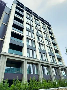 New building structure with modern design in urban location during daylight.. Stock Photos