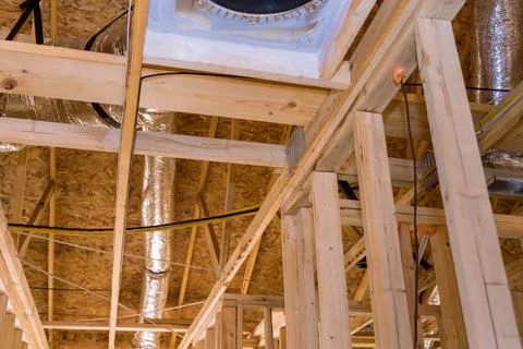 A new building under construction with installation of HVAC tubing vents heating Fotos de archivo