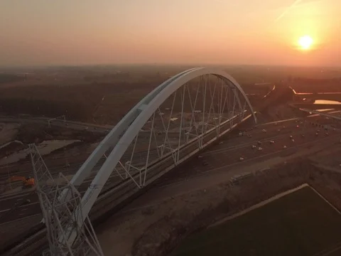 New built bridge on a highway with traffic, The Netherlands, aerial shot sunset Stock Footage 75406311