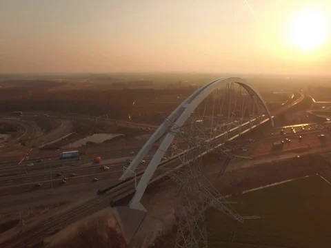 New built bridge on a highway with traffic, The Netherlands, aerial shot sunset Stock Footage