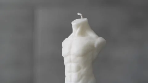 A new candle in the form of a man's torso. Stock Footage 267073067