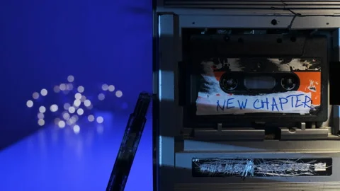New chapter sign on audio cassette label, which is inserted into old retro Stock Footage 158650127