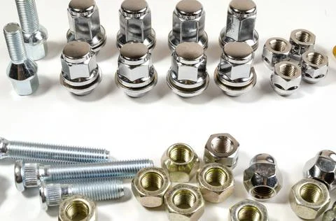 New chrome nuts and studs for repairing different cars Stock Photos