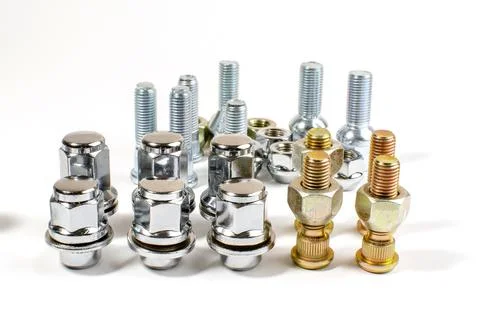 New chrome nuts and studs for repairing different cars Stock Photos