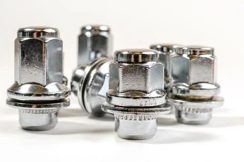 New chrome nuts and studs for repairing different cars Stock Photos