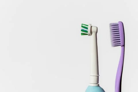 New clean electric automatic and manual toothbrushes toothpaste on a white backg Stock Photos