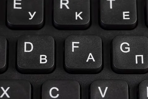 New computer keyboard layout with Latin and Cyrillic alphabet, close up Stock Photos