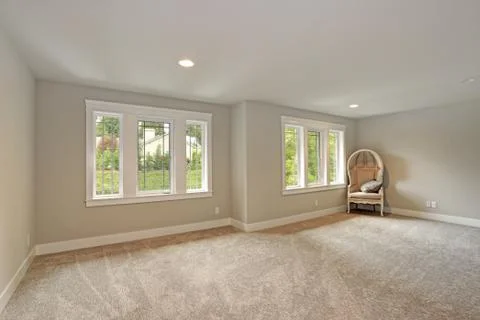New construction home interior features Empty room with cream paint color, be Stock Photos