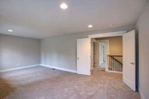 New construction home interior features Empty room with light grey walls pain Stock Photos