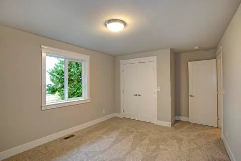 New construction home interior features Empty room with beige walls paint col Stock Photos