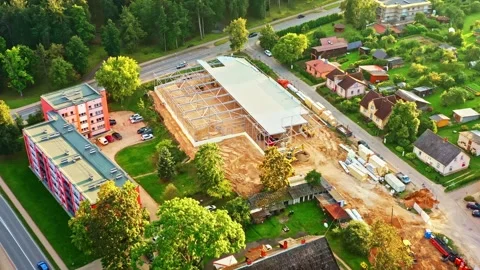 New construction of retail store or warehouse with built steel frame in aerial Stock Footage 334747458