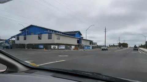 New construction site, featuring a building wrapped in blue material Stock Photos