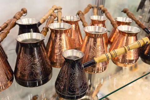 New copper coffee pots on display in a store. Coffee shop Stock Photos