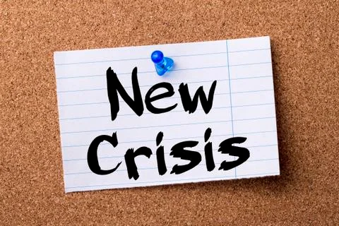 New Crisis - teared note paper pinned on bulletin board Stock Photos