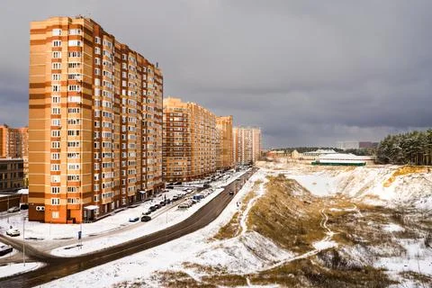 New development highrises after the first snow with heavy dark cloud overcast Stock Photos