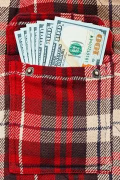New dollar notes in checkered shirt pocket Stock Photos