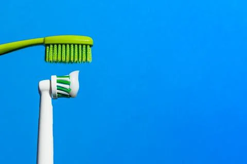 New electric automatic toothbrush with toothpaste vs manual toothpaste. Stock Photos