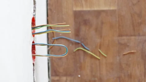 New electrical copper cables hanging out from wall socket boxes Stock Footage 339298328
