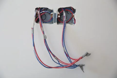 New electrical outlets in flat . Electrical wires, wiring, socket on an old c Stock Photos