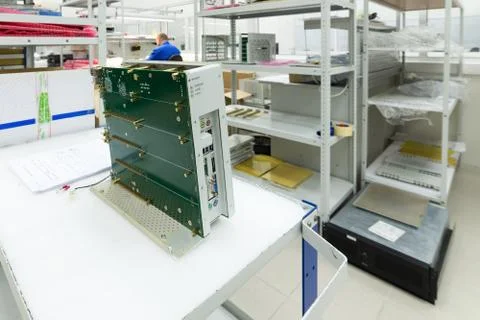 A new electronic module is on the assembly table. Stock Photos