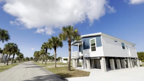New elevated mobile home resting on high concrete stilt pilings designed for Stock Footage 327513340