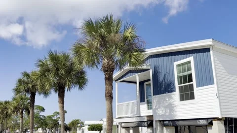 New elevated mobile home resting on high concrete stilt pilings designed for Stock Footage 327513395
