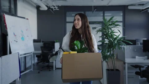 New employee is going through the open space. Woman with a box of things Stock Footage 257423735