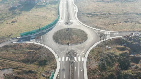 New empty four-lane road with roundabout (traffic circle) in rural countryside Stock Footage 145488003