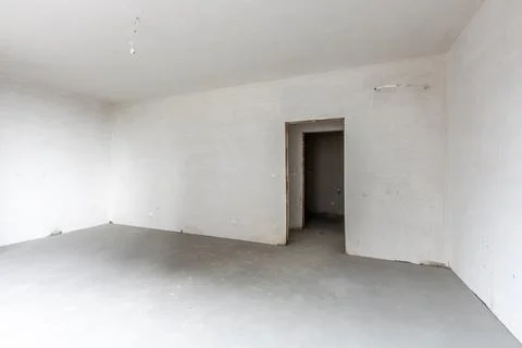 New empty room under construction. Plaster walls. New home. Concrete walls. I Stock Photos