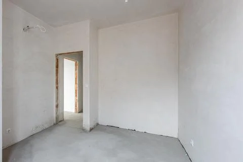 New empty room under construction. Plaster walls. New home. Concrete walls. I Stock Photos