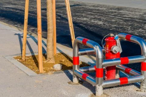 New fire hydrant next to paved road. Stock Photos