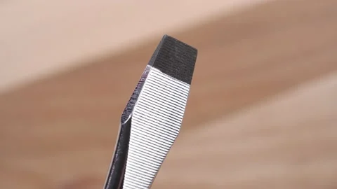 New flat metal stainless screwdriver on a wooden background Stock Footage 159418588