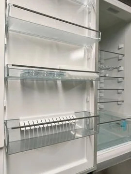 New fridge with a spacious interior and open door, available in electronics.. Stock Photos