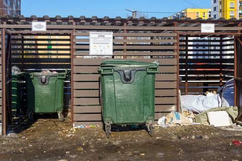 New garbage dump with garbage cans is wide open and garbage is around it 스톡 사진