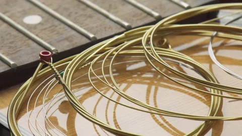 New guitar strings are ready to wind. Macro shot Video stock 329824025