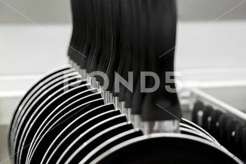 New hang in a row pans in the store. cooking utensils Stock Photos