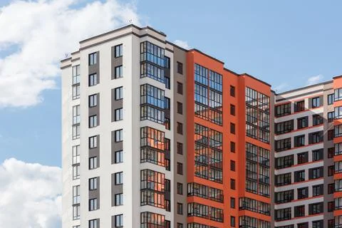 New high rise apartament building with multiple balcony and windows on blue sky Stock Photos