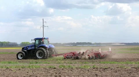 New Holland tractor plowing field Stock Footage 64128853