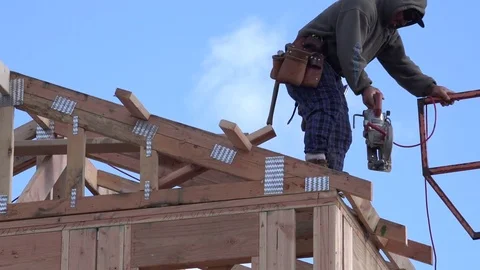 New Home Building, carpenter using electric saw on roof frame Stock-Footage 85037220