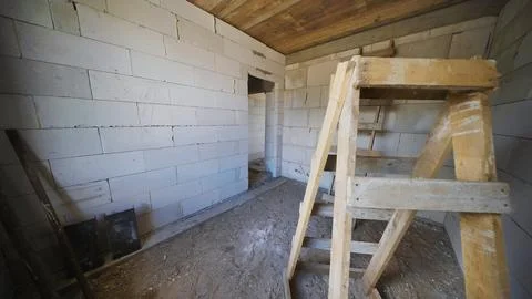 New home construction showing empty room with white cinder block walls and Stock Photos